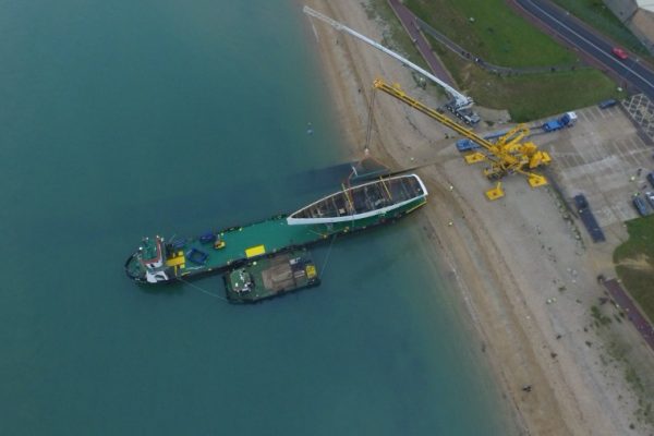 Loading large marine component onto transporter boat Loading large marine component onto transporter boat