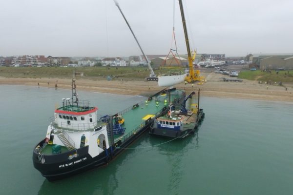 Loading large marine component onto transporter boat Loading large marine component onto transporter boat
